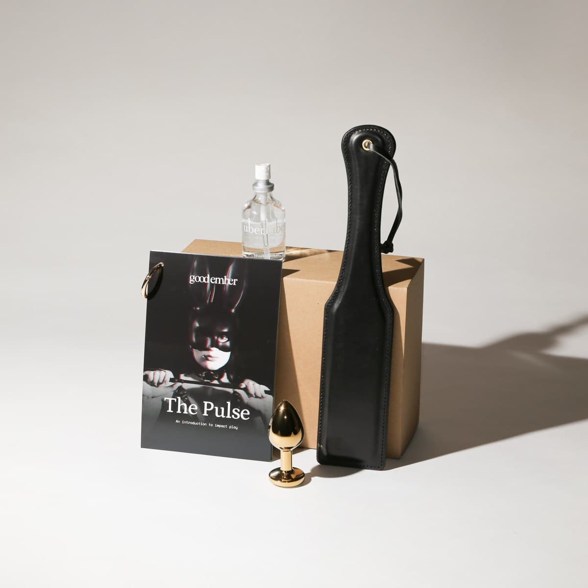 The Pulse kit: leather paddle, blindfold and guidance booklet with the box.